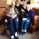 Middle-aged daughter with elderly mother and father.