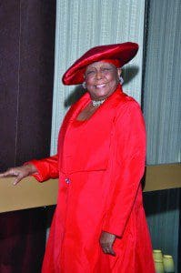 Lady in Red - Anne V. Moore, curator for the HATitude Program for ZORA! Festival 2012, matches her hat perfectly to her outfit at ZORA! Festival 2012. Photographer/Ted Hollins.
