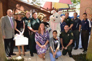 Back row, l-r: Sam Meiner & Eleanor Meiner (Founders of The Easter Bunny Foundation), Orange County Reserve Deputy Samuel May, DFC Carmelo Ortiz, Arnold Palmer pediatric patient, The Easter Bunny, Cindy Cutlip (Director of Foodservice-Restaurant Channel PepsiCo Foodservice Southeast Region), Orange County Reserve Deputy Dan Newlin, Jason Cutlip and Nelson (PepsiCo) Front row-kneeling, l-r: Khira Williams (Executive Assistant to the Easter Bunny), Christina (Child Life Services), and Orange County Reserve Deputy Tim Styer. (Photo credit: Frank J. Hahnel, III)