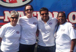 l-r: Pat Ruiz, rig driver; Monica Rutherford, Regional Manager, AHF; Marco Benjamin - Program Manager, Condom Nation Tour and Jennifer Kitchen, stand in front of the 18-wheeler big rig, March 19, 2013. (Photo: WONO)