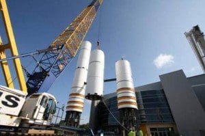 Construction crews successfully installed lower portions of two full-size, high-fidelity solid rocket boosters (SRBs) that, when vertically mated with a high-fidelity model of the external tank (ET), will form a dramatic, 184-foot-tall gateway under which visitors will pass to visit the Space Shuttle Atlantis attraction. (Photo: NASA)
