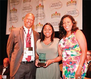 NNPA Publishers Charles W. Cherry II, left, and Karen Carter Richards, right, flank an award winner during Merit Award ceremonies. (COURTESY OF KELVIN BRAXTON FOR NNPA)
