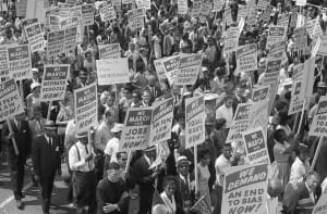 Demonstrators marching in the street holding signs during the March on Washington, 1963. Photo by: Marion S. Trikosko.