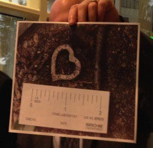 OCSO Supervisor Jason McMullen holds up a photograph of the pendant found with the skeletal remains of an African-American female found ... at a media briefing, September 23, 2013, OCSO Central Operations Building. (Photo: WONO)
