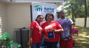 Sherall Leo and children pose with the keys to their new home. 