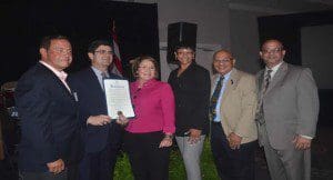Mayor Teresa Jacobs is joined by the president of the Puerto Rican Chamber of Commerce of South Florida Luis De Rosa, Executive Director of Puerto Rico Trade and Export Company Francisco Chévere, City of Kissimmee Commissioner Wanda Rentas, District 48 State Representative Victor Manuel Torres, Jr., and City of Kissimmee Former Commissioner Art Otero. (Photo: Orange County government)